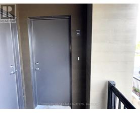 A black door with a handle and a keyhole is in a room.