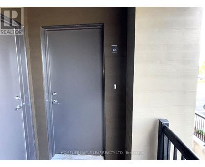 A black door with a handle and a keyhole is in a room.