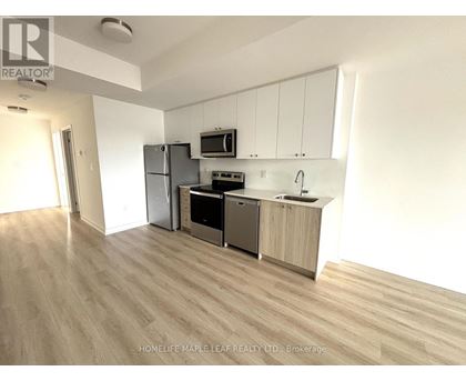 A kitchen with wooden floors and white walls.