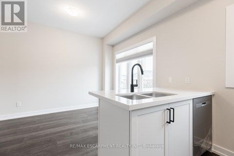 A kitchen with a sink and a window.