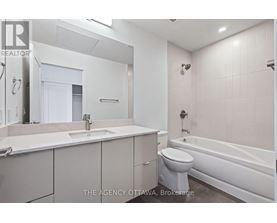 A white bathroom with a toilet, sink, and bathtub.