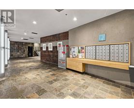 A real estate office with a brick wall and a row of mailboxes.