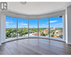 A room with a large window overlooking a cityscape.