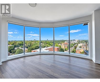 A room with a large window overlooking a cityscape.