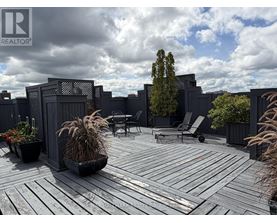 A wooden deck with a table and chairs surrounded by a fence.