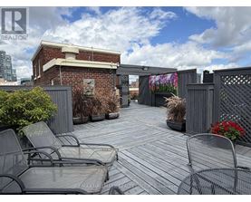 A patio with chairs and a table is surrounded by a brick wall.