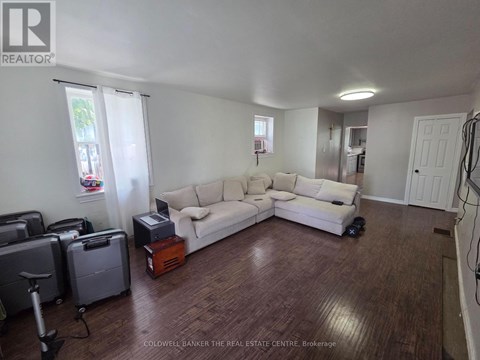 A living room with a white couch and a brown coffee table.