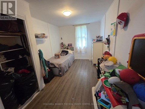 A bedroom with a bed, a desk, and a closet.