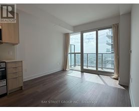 A spacious room with a view of the beach through large windows.
