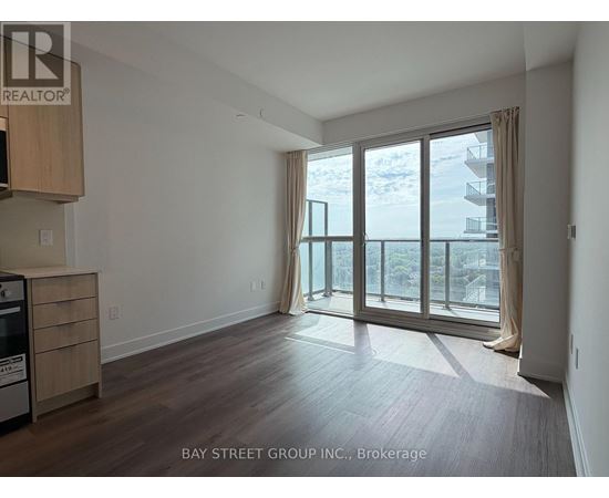 A spacious room with a view of the beach through large windows.