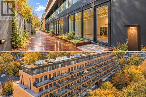 A modern building with a wooden walkway and glass doors.