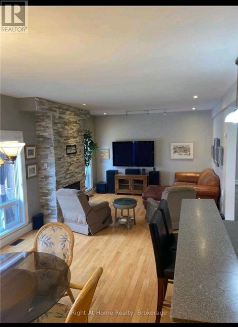 A living room with a stone pillar and a flat screen TV.