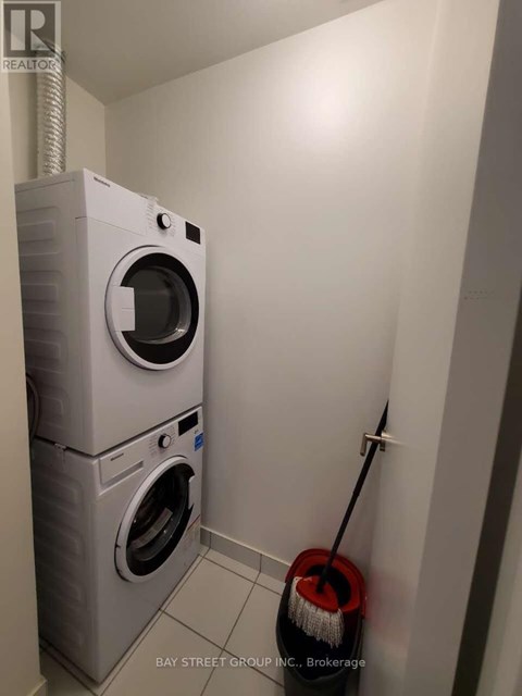 A white washing machine and dryer in a small laundry room.