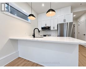 A modern kitchen with white cabinets and a large island.