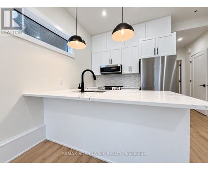 A modern kitchen with white cabinets and a large island.
