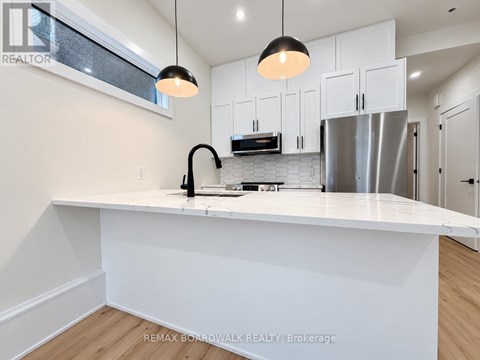 A modern kitchen with white cabinets and a large island.