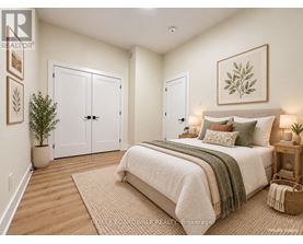 A bedroom with a large bed and a potted plant.