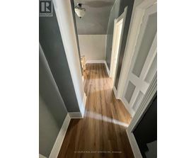 A room with a window and wooden flooring.
