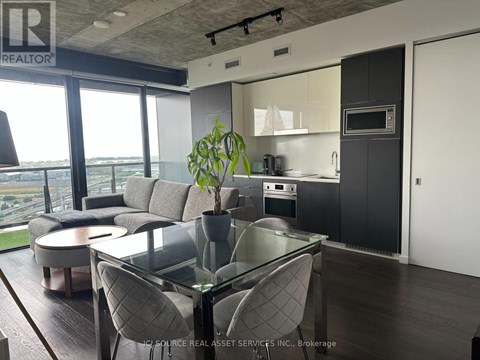 A modern kitchen with a glass table and chairs.