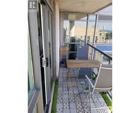 A balcony with a table and chairs.