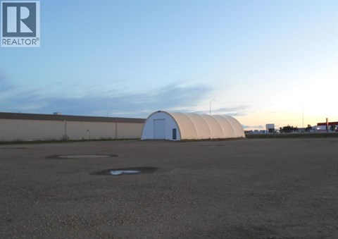 A large white dome structure sits in the middle of a parking lot.