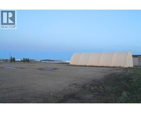 A large, empty field with a REALTOR® logo in the corner.