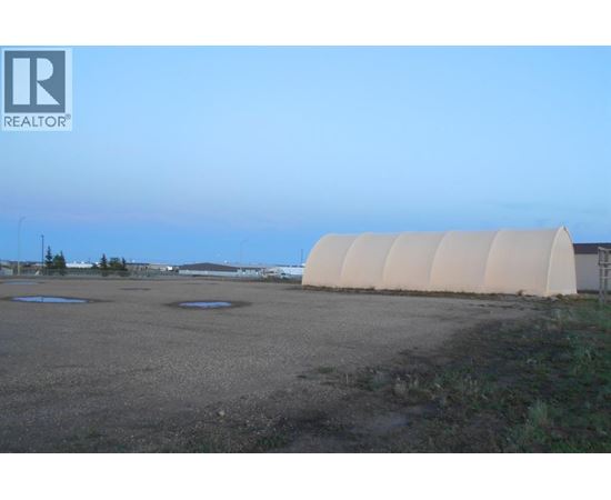 A large, empty field with a REALTOR® logo in the corner.