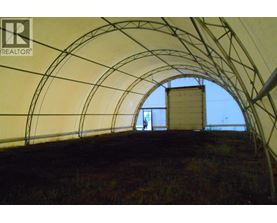 A man is standing in a tunnel with a REALTOR sign on the wall.