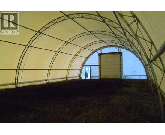 A man is standing in a tunnel with a REALTOR sign on the wall.