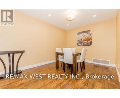 A dining room with a table and chairs.