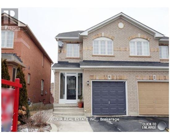 A brick house with a red gate in front.