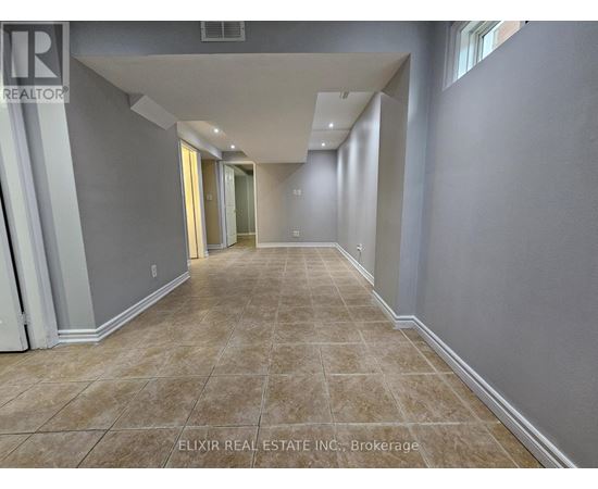 A long, empty hallway with tiled flooring and white walls.