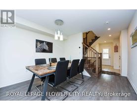 A dining room with a wooden table and chairs.