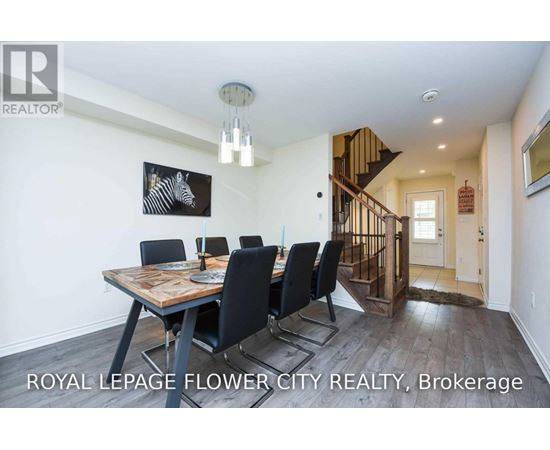 A dining room with a wooden table and chairs.