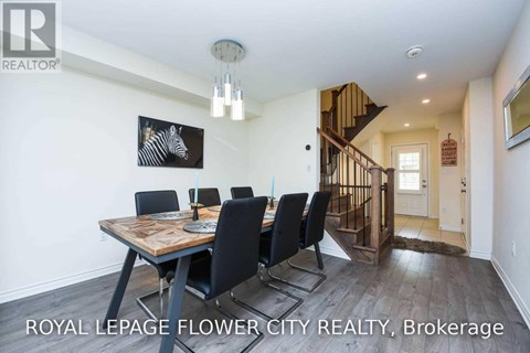 A dining room with a wooden table and chairs.