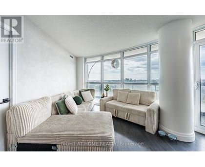 A living room with two couches and a large window.