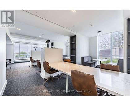 A conference room with a long table and chairs.