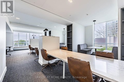 A conference room with a long table and chairs.