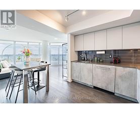 A modern kitchen with a dining table and chairs.