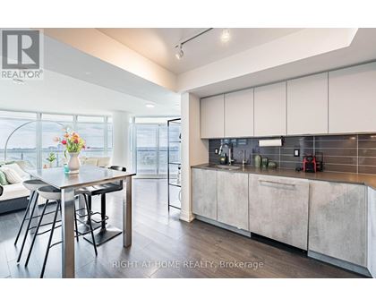 A modern kitchen with a dining table and chairs.