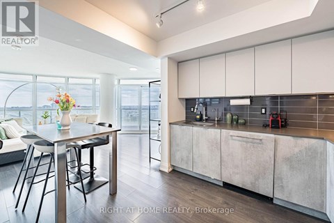 A modern kitchen with a dining table and chairs.