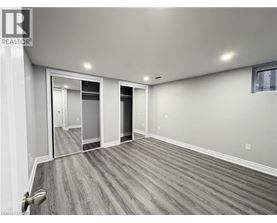 A spacious room with a grey floor and white walls.
