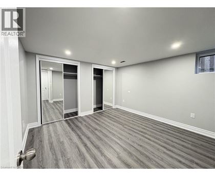 A spacious room with a grey floor and white walls.