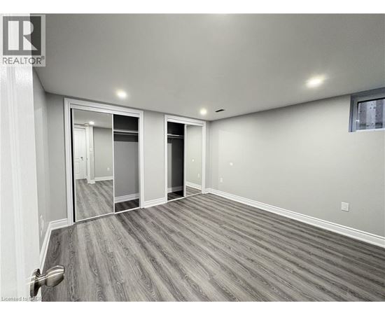 A spacious room with a grey floor and white walls.
