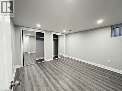 A spacious room with a grey floor and white walls.