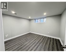 A room with wooden flooring and a window.