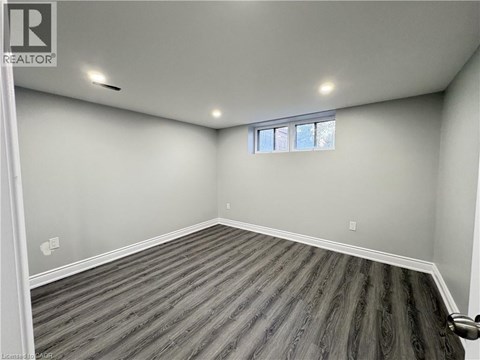 A room with wooden flooring and a window.
