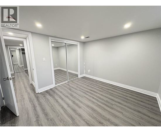 A room with a realtor sign on the wall.