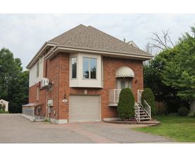 A house with a brick facade and a garage door.