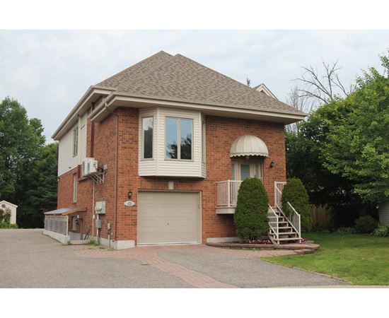 A house with a brick facade and a garage door.